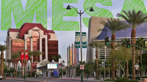 Downtown street scene with buildings and palm trees under a green 'AES' text overlay.